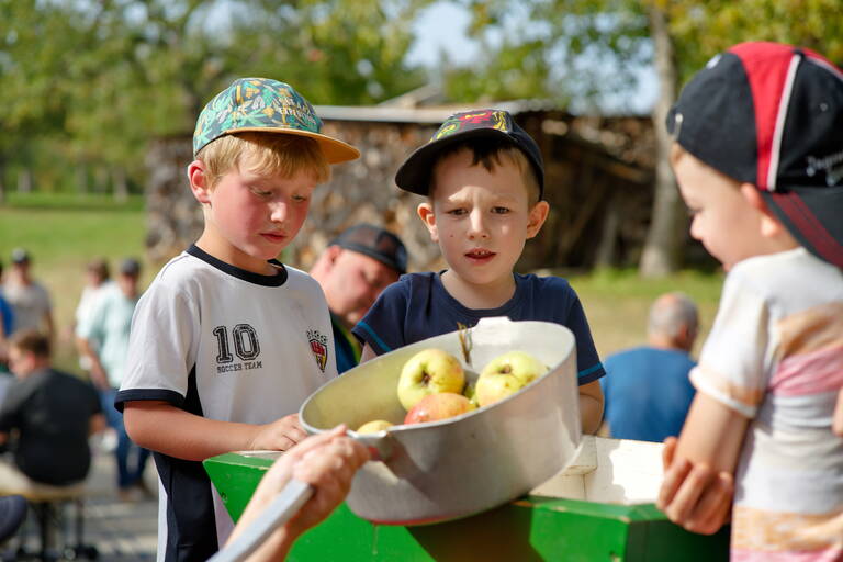 Kinder an der historischen Apfelpresse auf dem Apfelfest am Walddorfer Streuobstpfad.